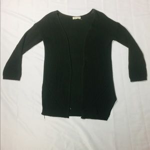 This a olive green cardigan and its 100% acrylic.